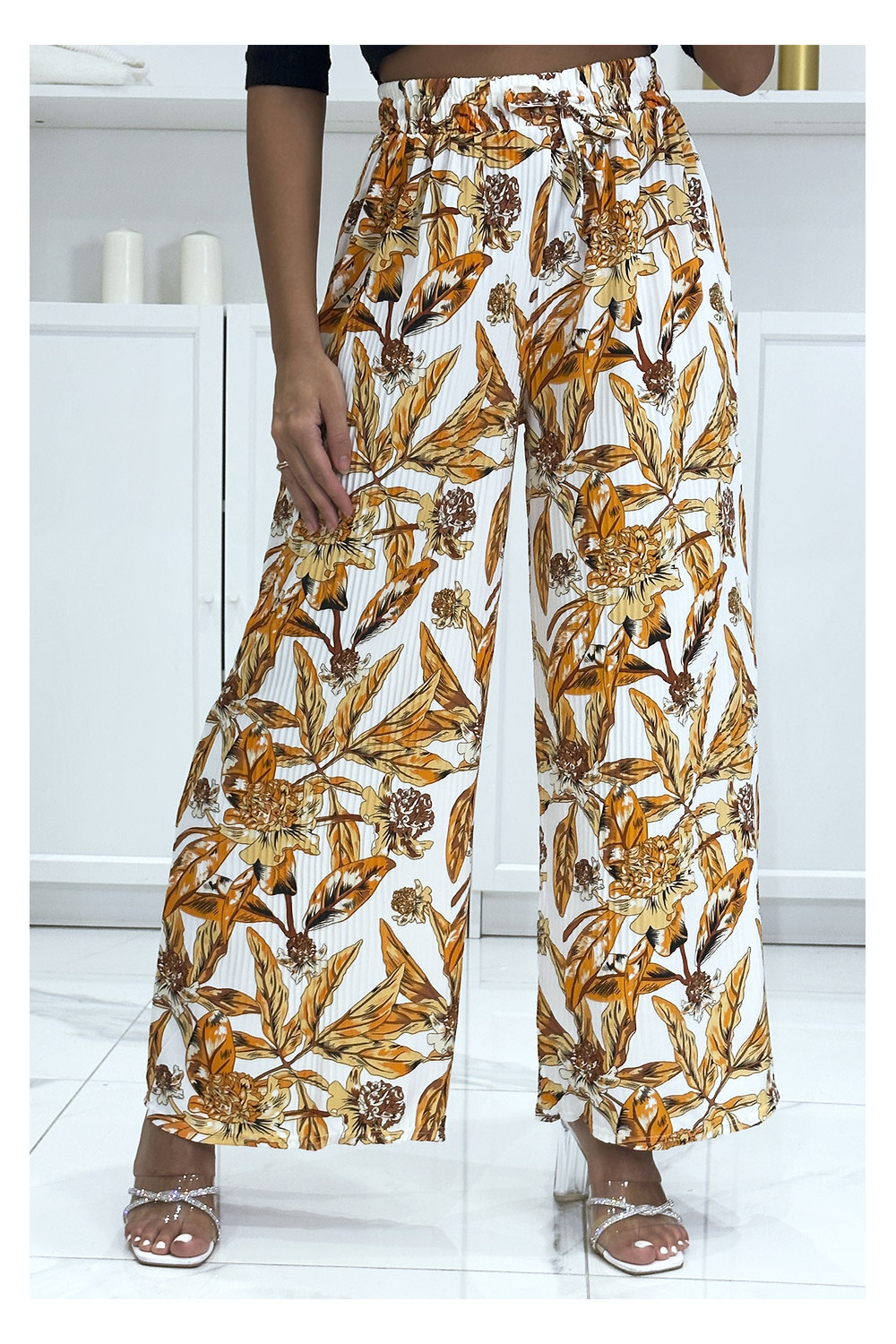 Orange pleated palazzo pants with floral pattern